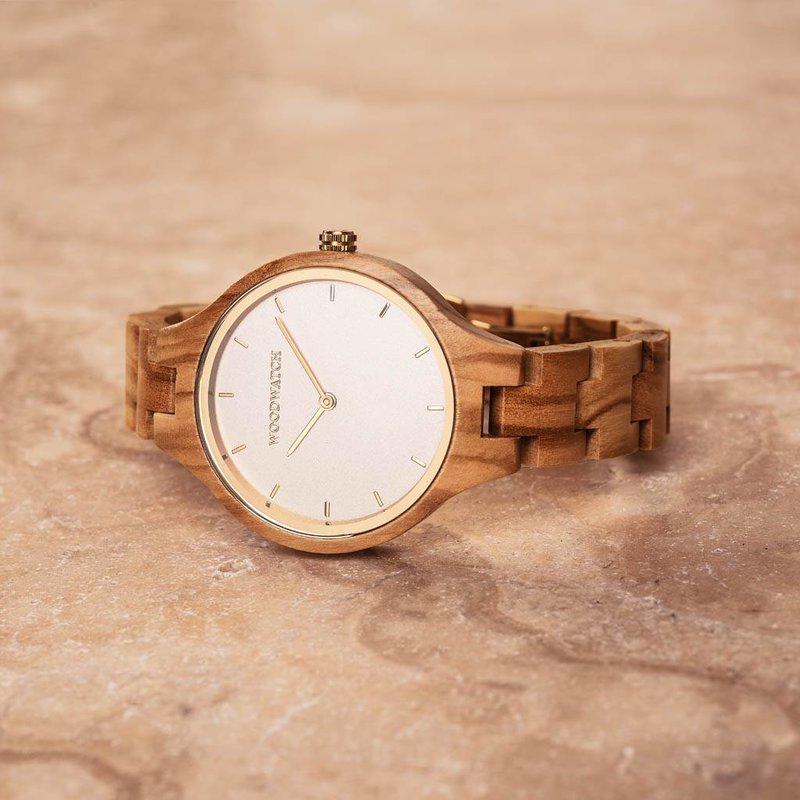 The AURORA Collection breaths the fresh air of Scandinavian nature and the astonishing views of the sky. This light weighing watch is made of European Olive Wood, accompanied by a light stainless-steel dial with a golden highlight and shining golden detai